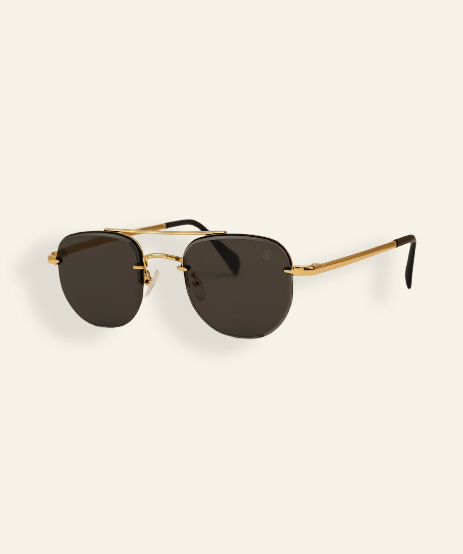 authentic rip wheeler yellowstone sunglasses with gold frame and dark lenses.