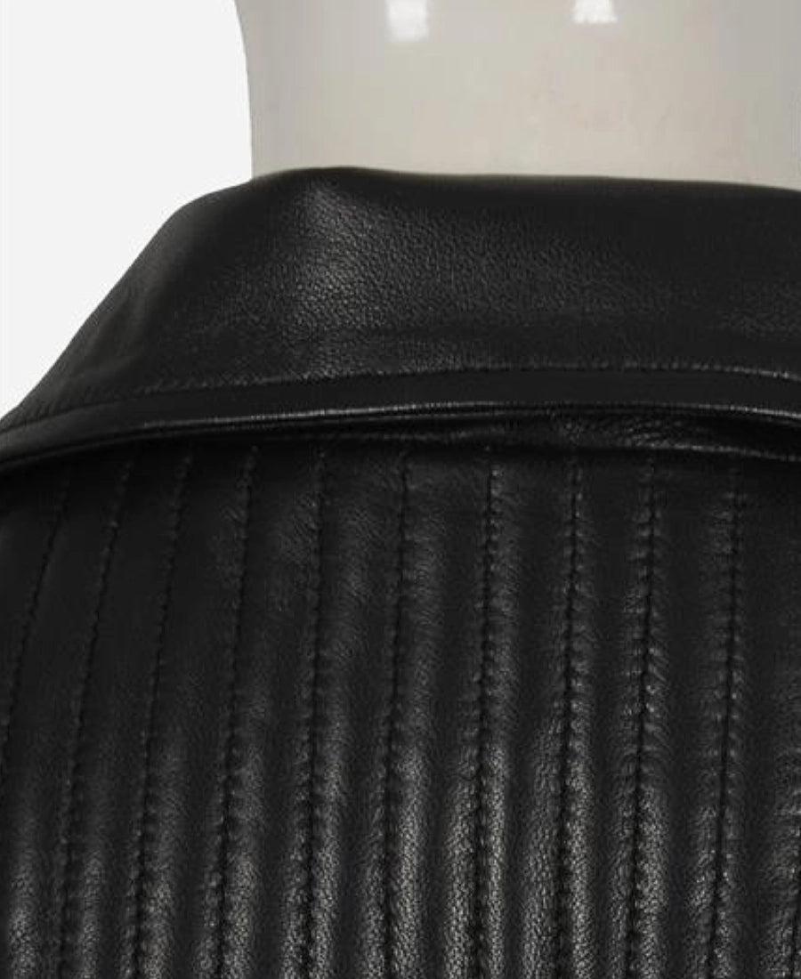 Close-up of a black leather jacket on a mannequin with a white background
