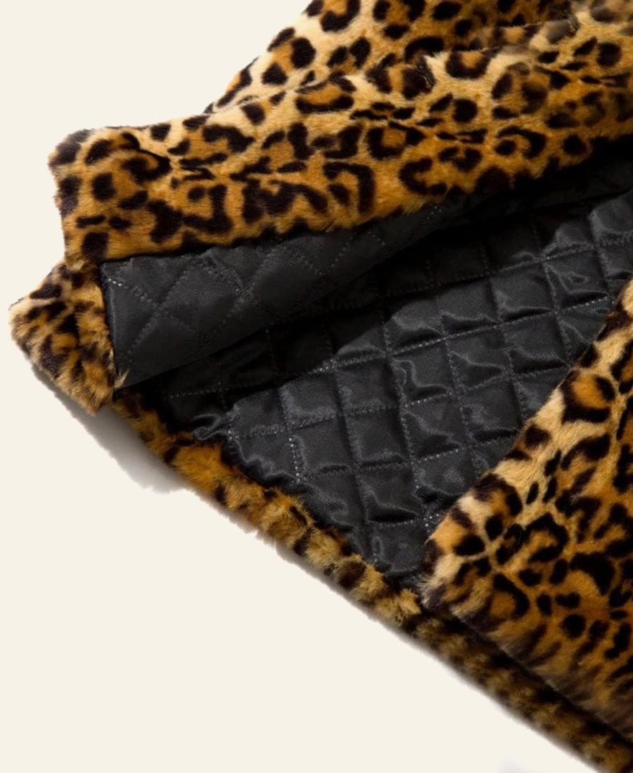 Folded leopard print fabric with textured black interior on a light background
