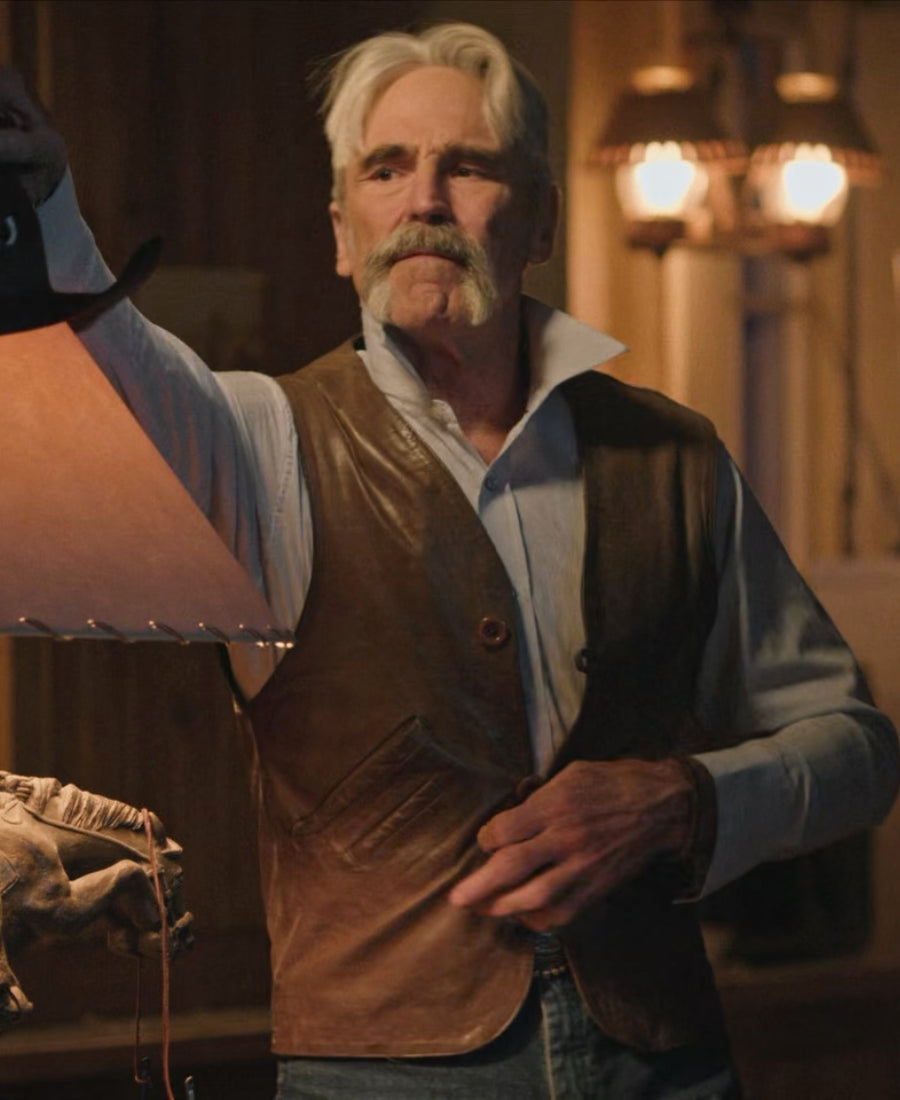 Forrie J.Smith Yellowstone Lloyd Pierce Brown Leather Vest standing in a dimly lit room with warm lighting.