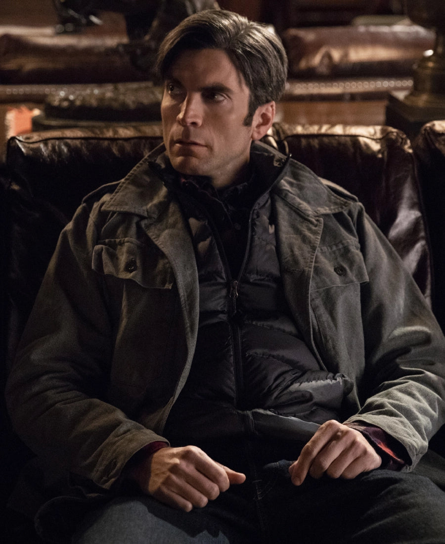 Jamie Dutton sitting in a dimly lit room wearing a Grey Cotton jacket.