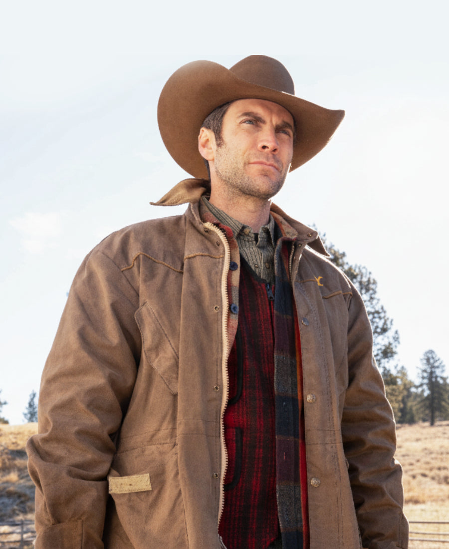 Jamie Dutton wearing a brown cowboy hat and Leather jacket 
