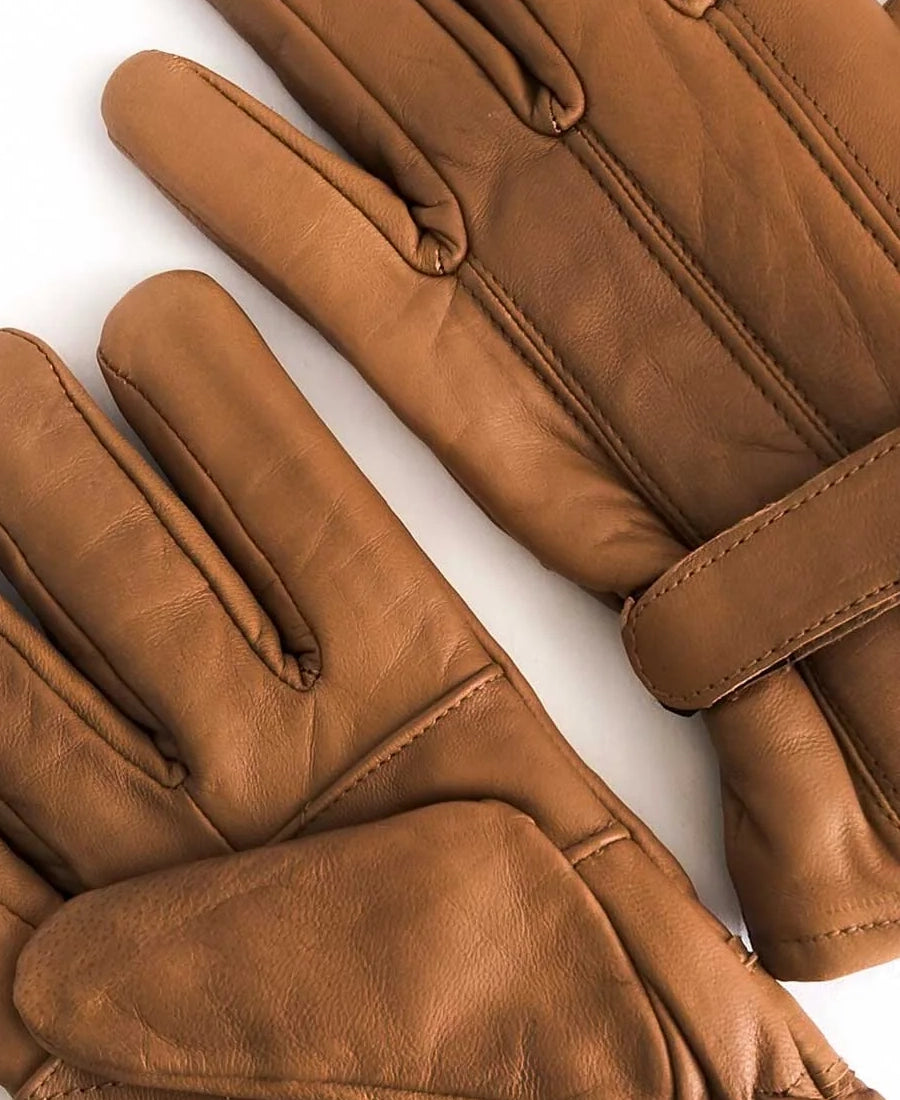 John Dutton Pair of brown leather gloves on a white background