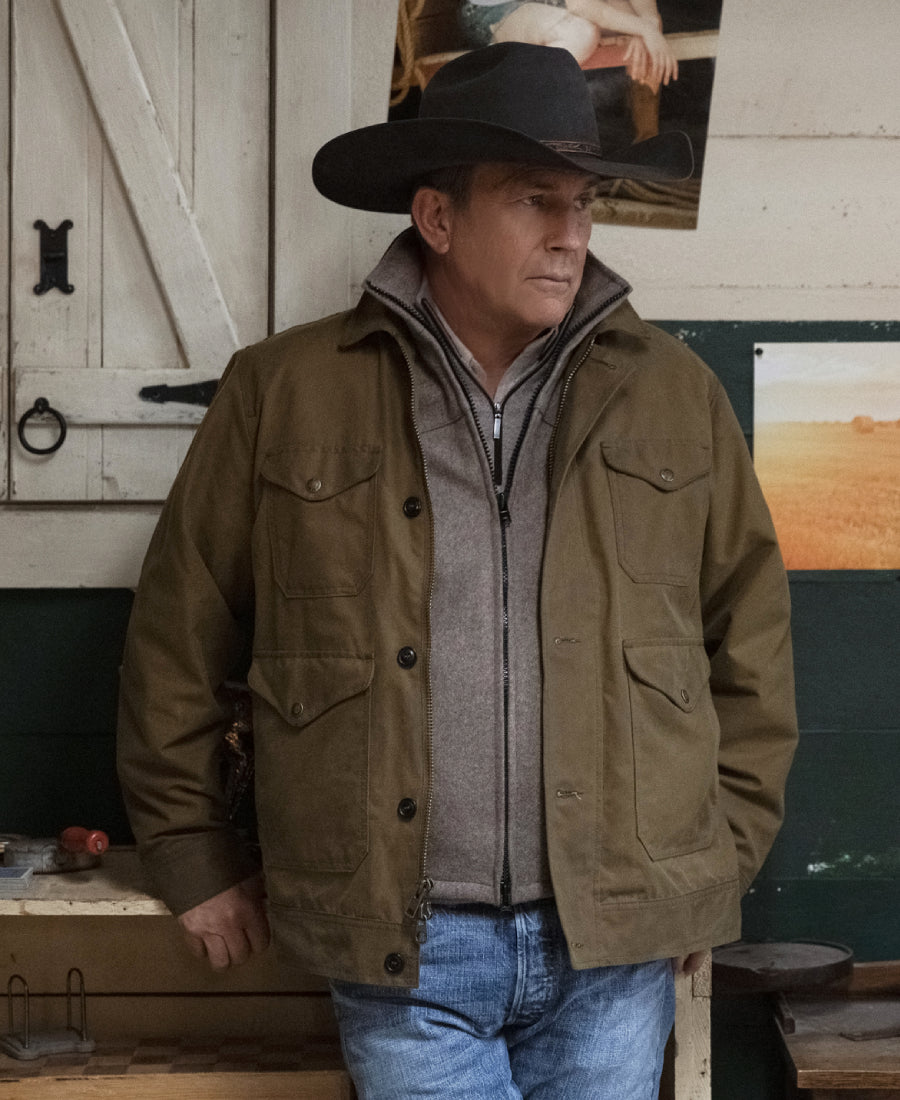 John Dutton wearing a brown jacket and cowboy hat