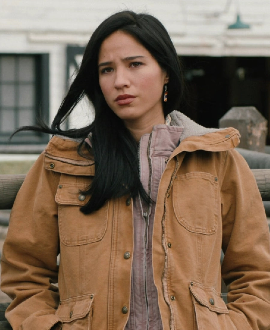 Monica Dutton wearing a brown jacket with a blurred background