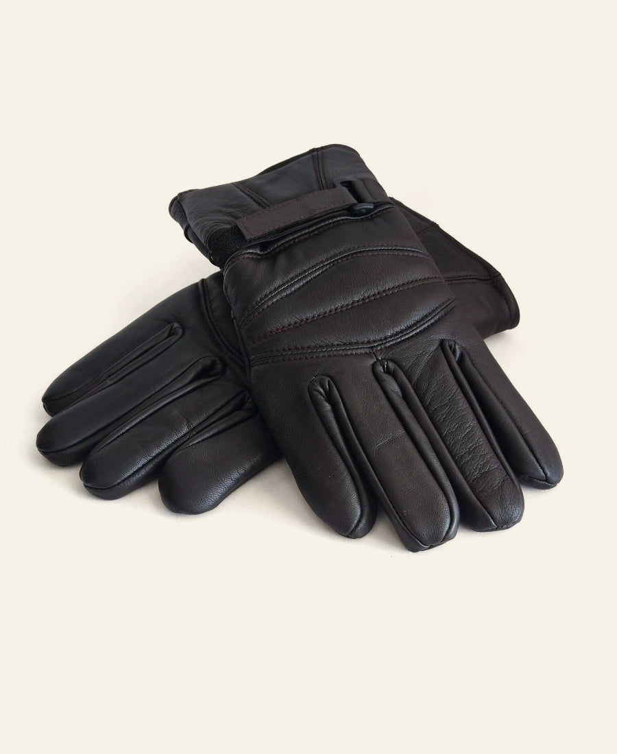 Rip Wheeler Pair of black leather gloves on a light beige background