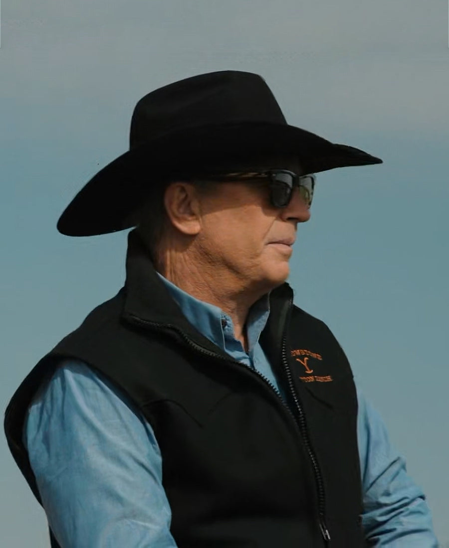 John Dutton wearing a black cowboy hat and black vest 