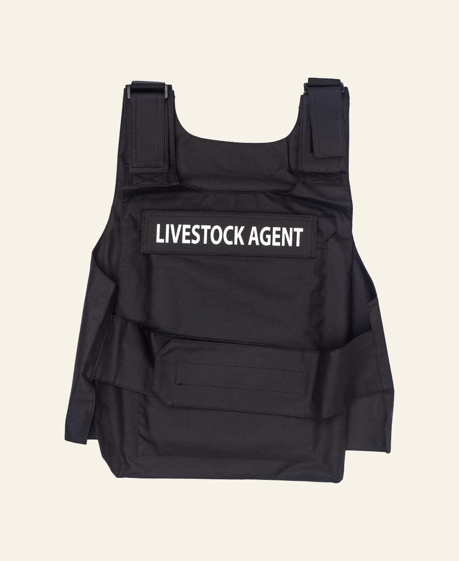 Yellowstone TV Series Black vest with 'LIVESTOCK AGENT' text on a beige background