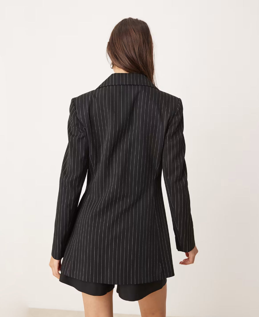 Beth dutton wearing a black pinstripe blazer on a white background