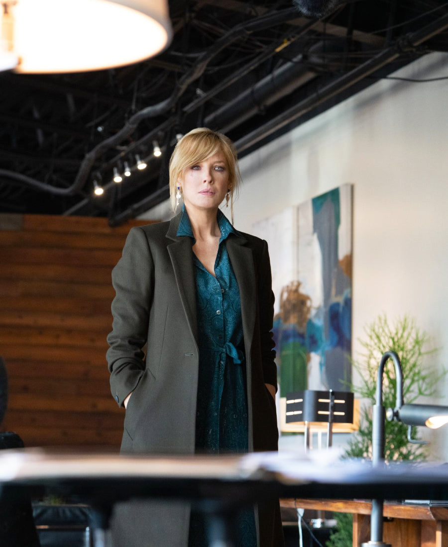 Beth Dutton wearing a gray coat 