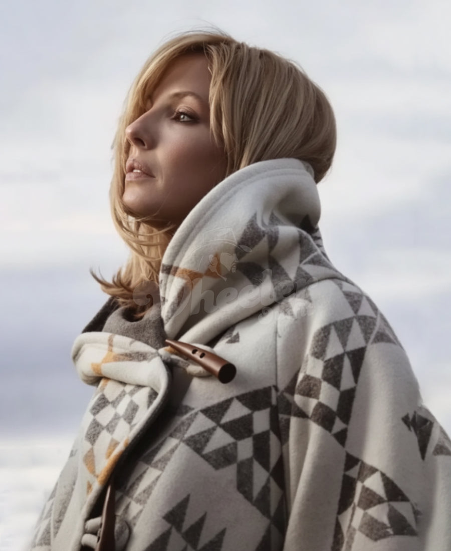 Beth Duton wearing a cloak coat against a cloudy sky