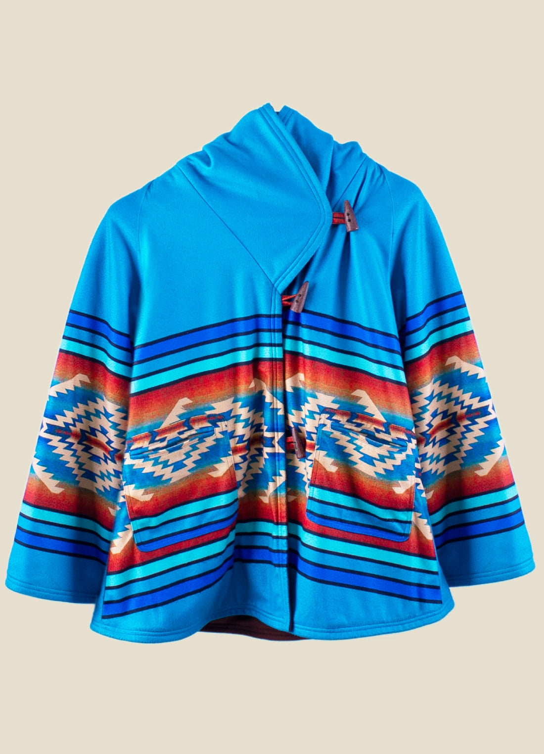Beth Dutton Blue Coat with colorful pattern on a beige background