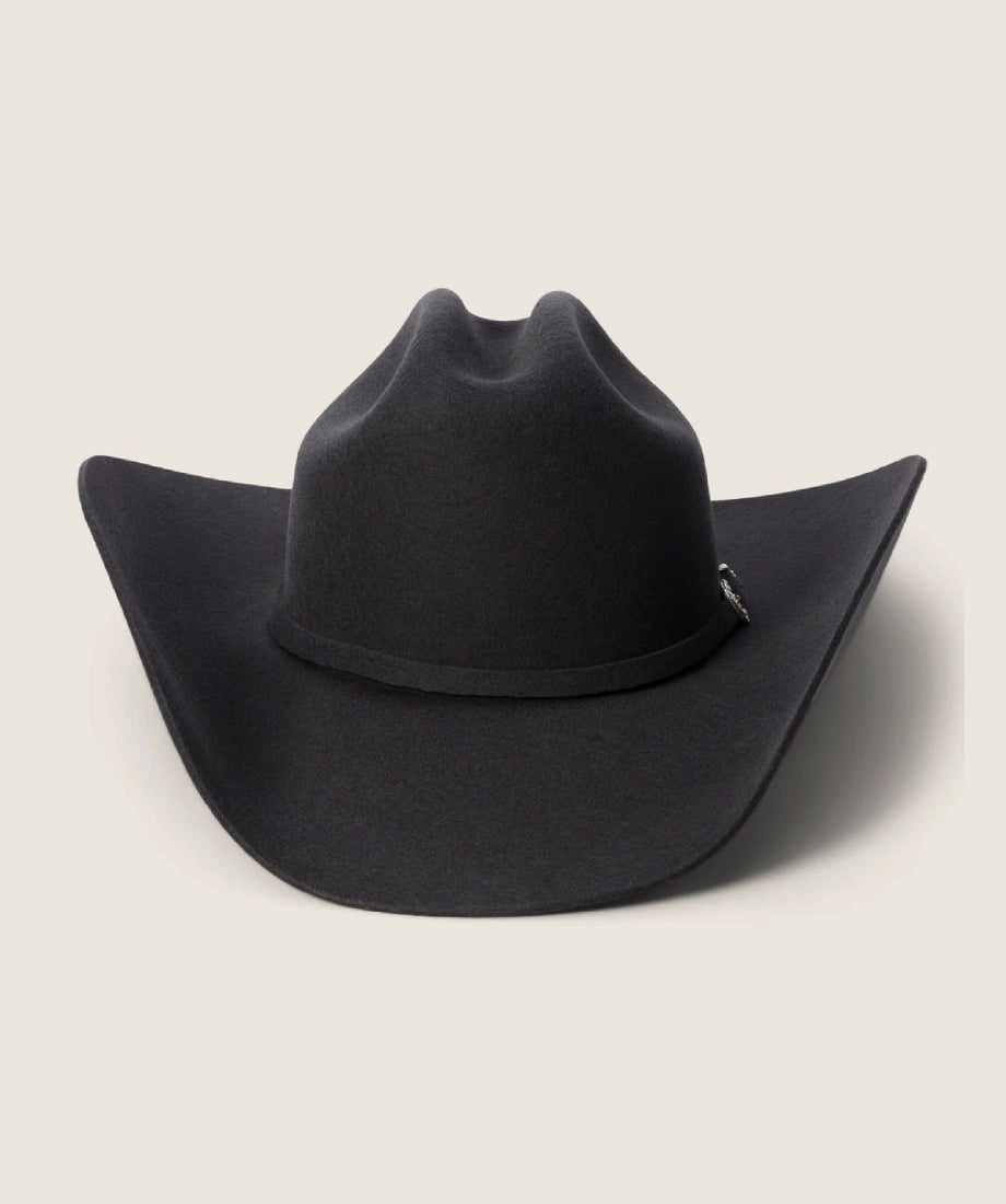 Black rip wheeler cowboy hat on a light beige background