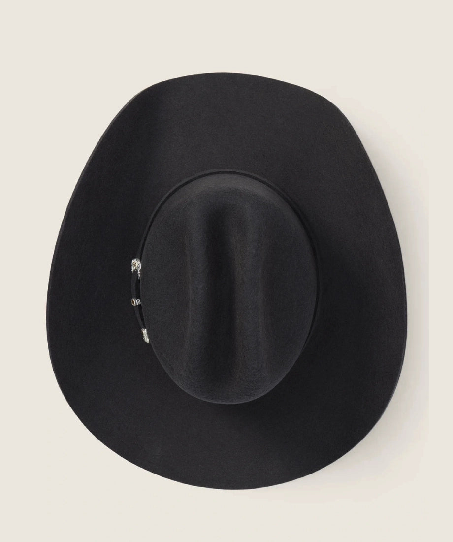 Black fedora hat on a light gray background