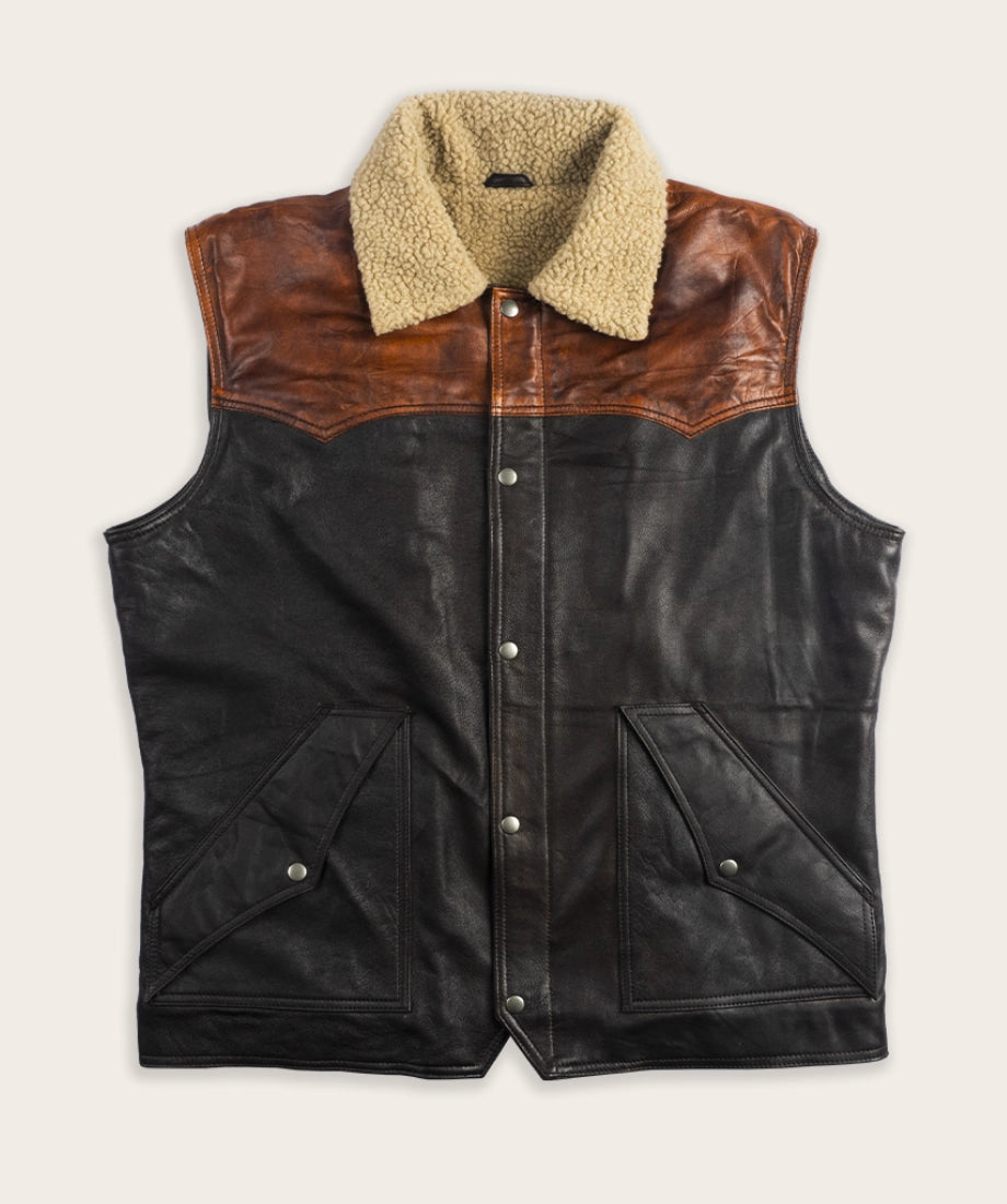 Black leather vest with brown leather collar and beige sherpa lining on a white background