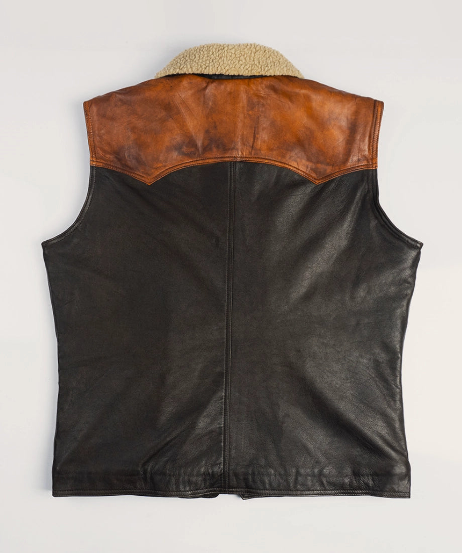 Black leather vest with brown leather collar on a light beige background
