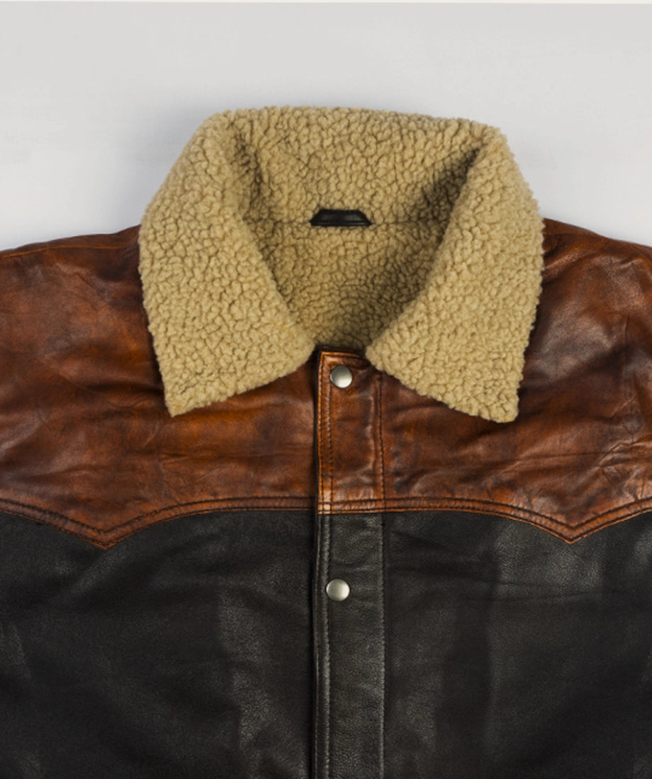 Brown leather jacket with beige sherpa lining on a light gray background