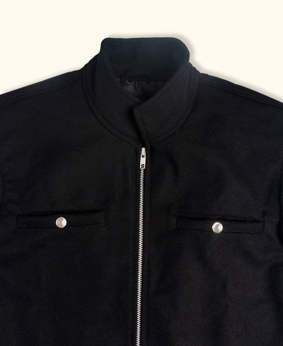 Black wool vest with a zipper on a white background closeup 