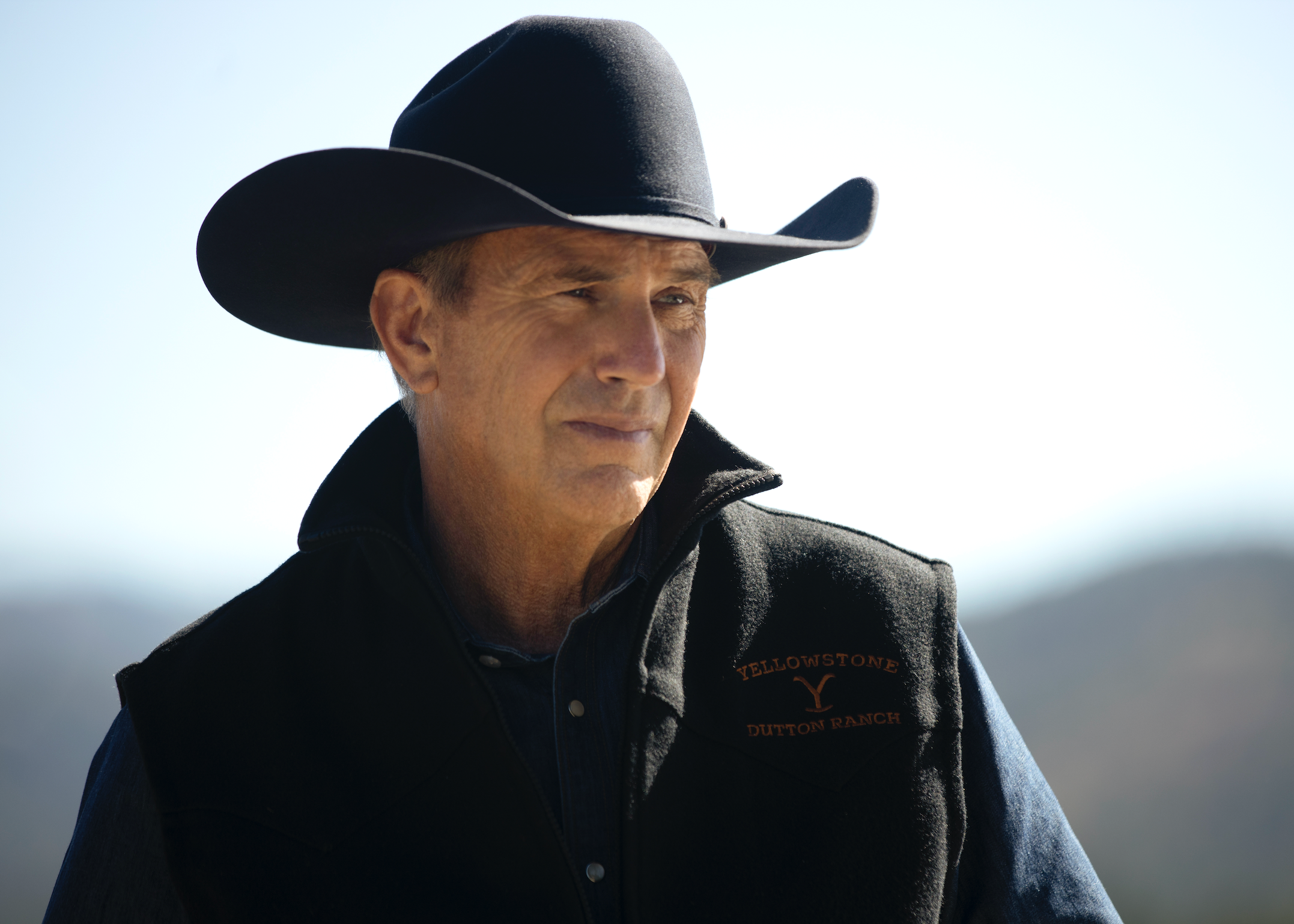 Man wearing a cowboy hat and black vest Yellowstone season 5 