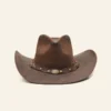 Brown leather cowboy hat with decorative band on a beige background