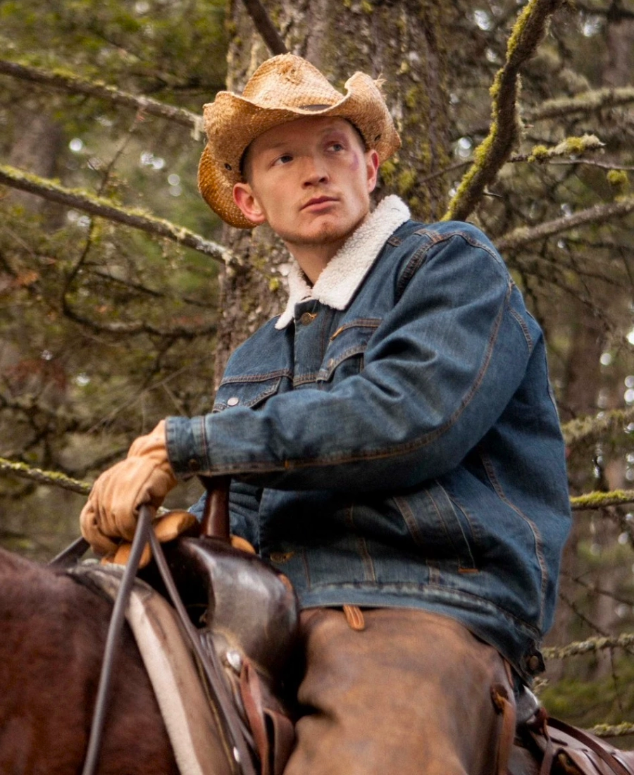 Jefferson White Sherpa lined denim jacket wearing a cowboy hat and sitting on a horse.
