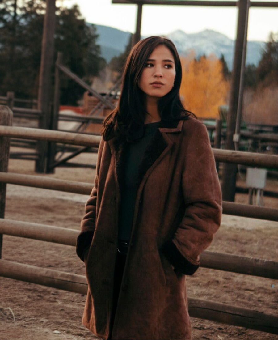 Monica Dutton Suede Leather Coat in front of a wooden fence