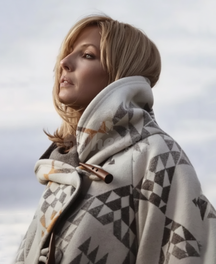 Beth Duton wearing a cloak coat against a cloudy sky