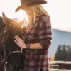 Beth Dutton Wear a Wool Maroon plaid shirt and cowboy hat petting a horse with mountains in the background