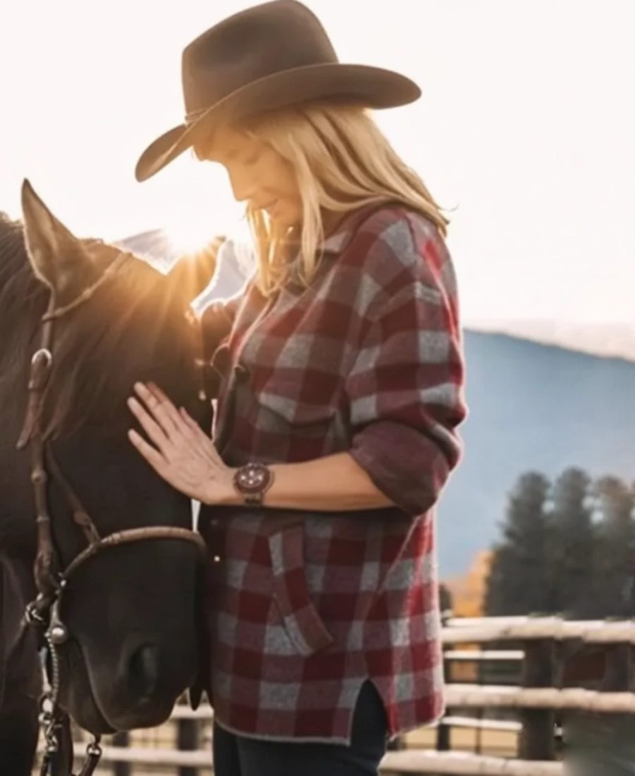 Beth Dutton Wear a Wool Maroon plaid shirt and cowboy hat petting a horse with mountains in the background