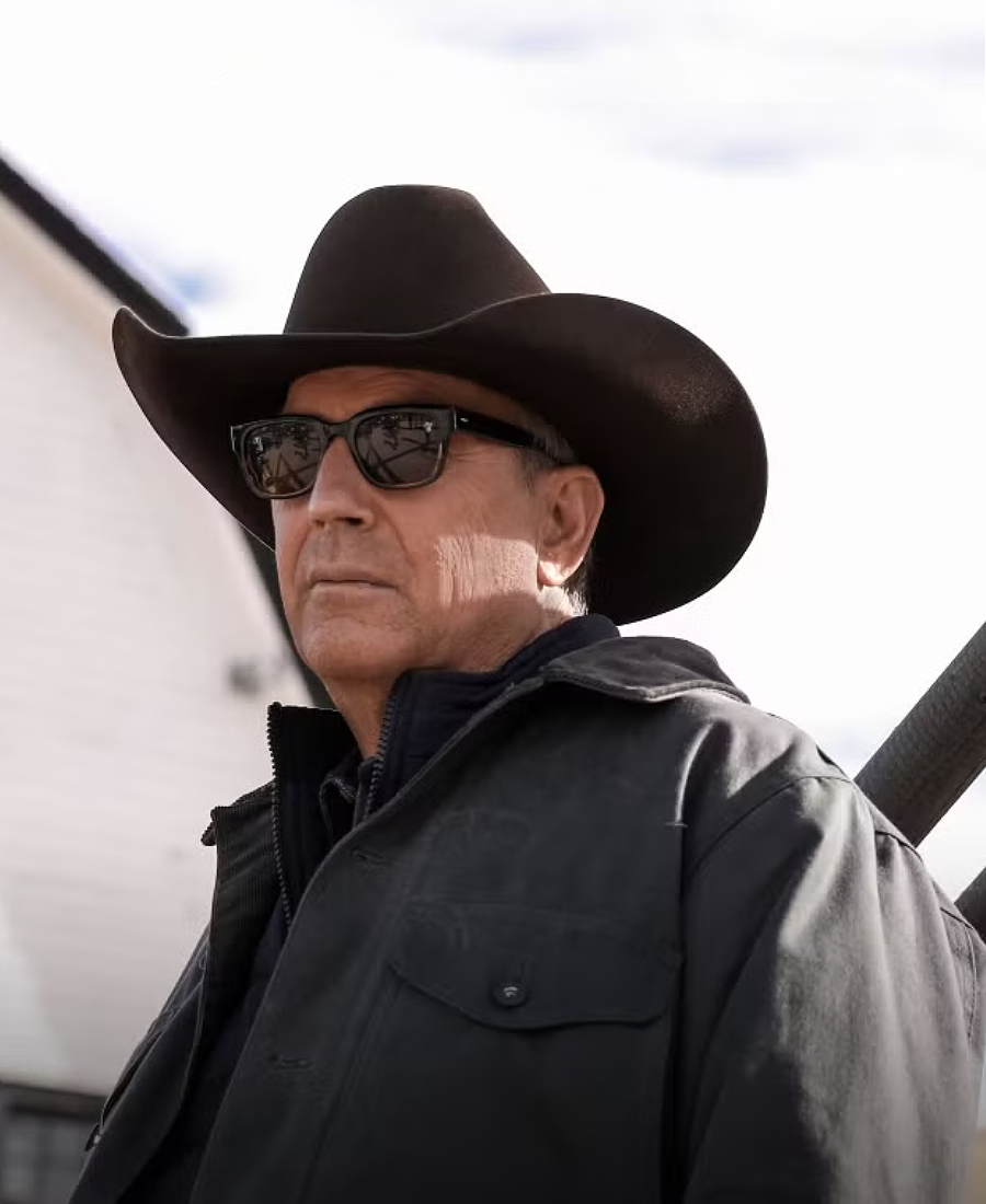 John Dutton wearing a cowboy hat and sunglasses with a neutral background