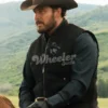 black wool Man wearing a black 'Wheeler Outfit' jacket with a cowboy hat and gloves, standing in a scenic outdoor setting.