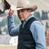 Man wearing a cowboy hat and vest in a scenic outdoor setting Yellow stone John Dutton