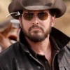Rip Wheeler wearing a cowboy hat and sunglasses with a blurred background