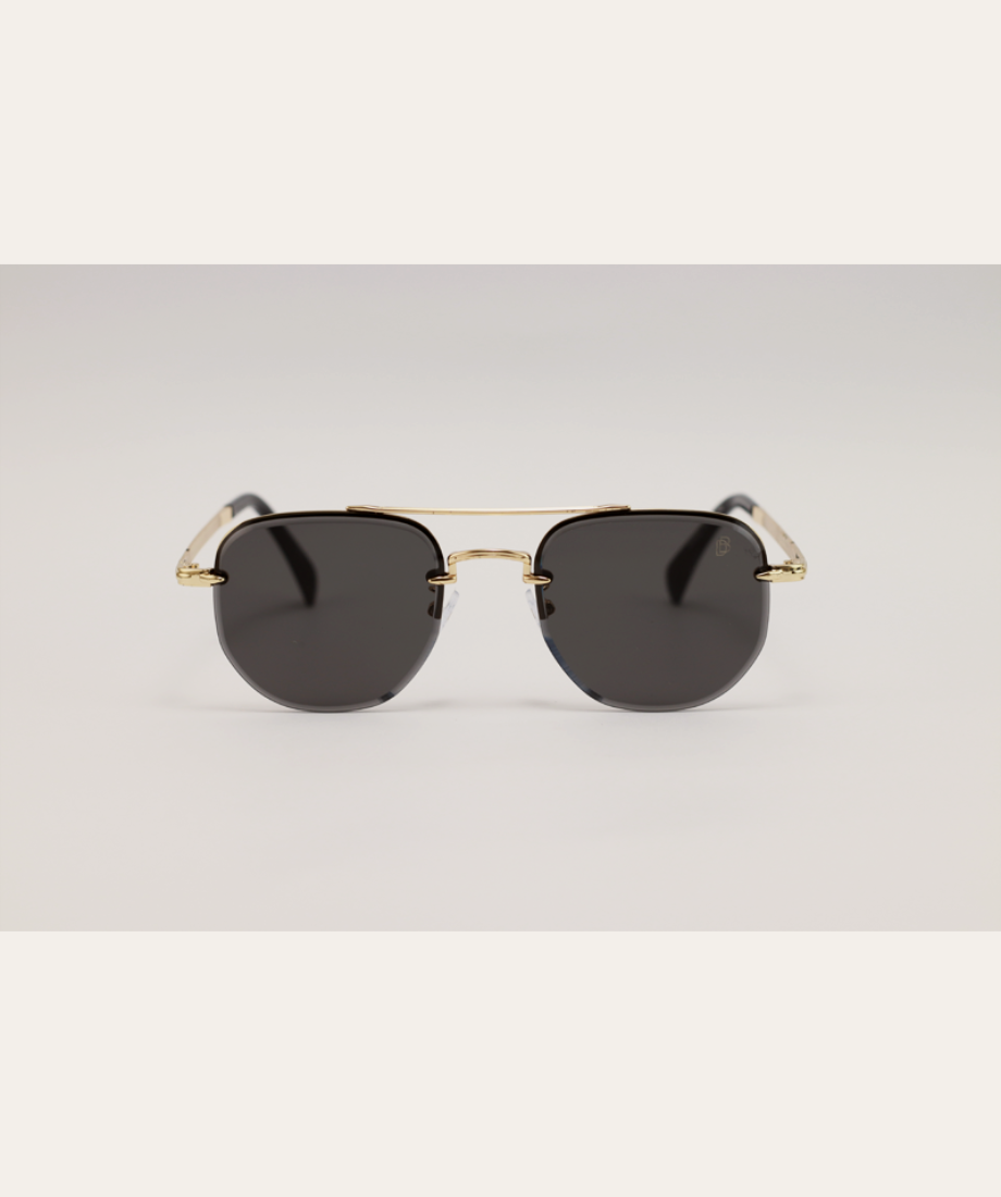 Yellowstone Rip Wheeler Sunglasses with gold frame and black lenses on a light gray background